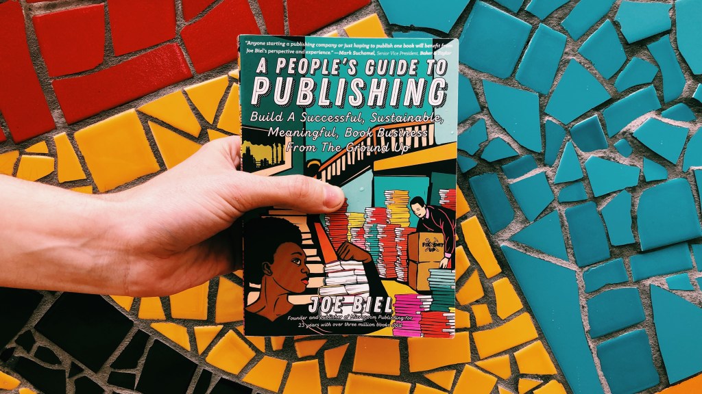 This is an original photograph by Independent Book Review of the paperback book of A People's Guide to Publishing on a multi-colored background