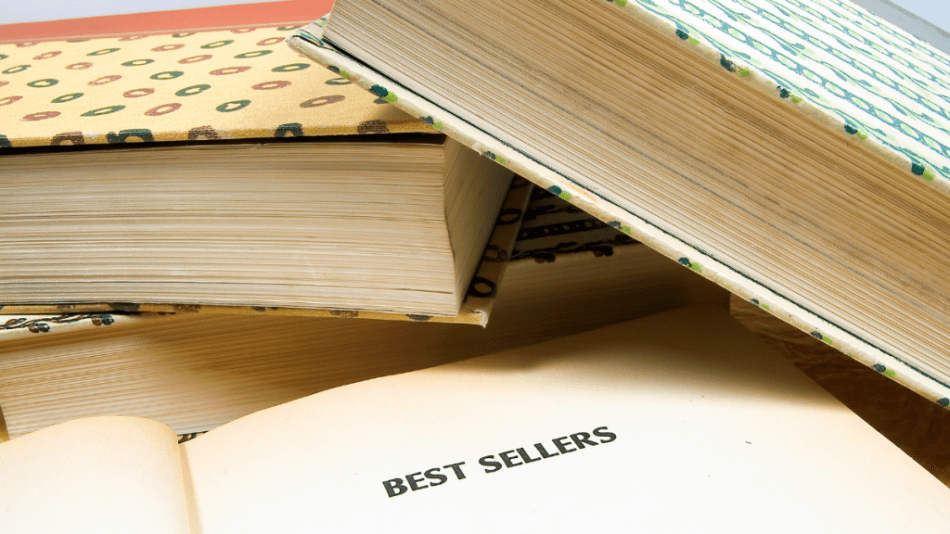 books stacked on top. ofeach other with best sellers on one of them